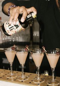 A bartender pouring Joila olive-oil cocktails