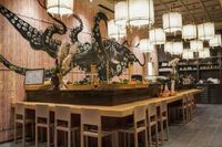 SushiCo restaurant interior with an octopus mural