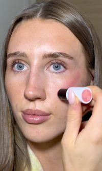 A creator applying an İNO cream blush stick to the cheek
