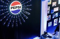 An illuminated Pepsi logo wall at a restaurant launch